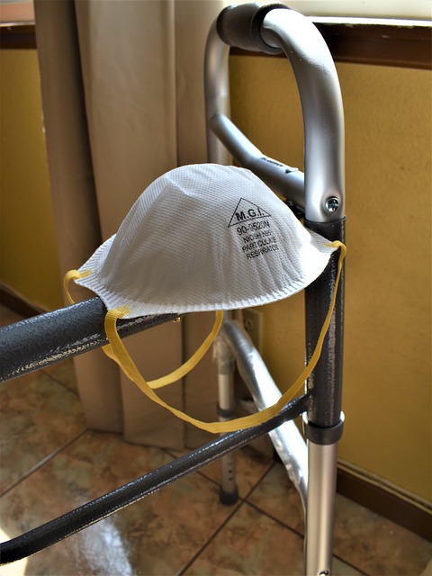 A photo of a walker with a N95 face mask resting on it.