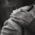 Close-up of an elderly couple showing warmth and connection. One hand rests gently on a shoulder.