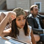 A couple having an intense discussion while seated in a convertible car.