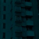 A high-rise residential block at night showcasing urban architecture and city living.